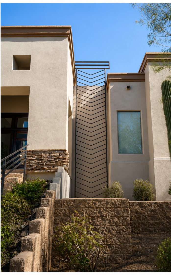 Steel chevron privacy screen set between two desert-modern stucco volumes