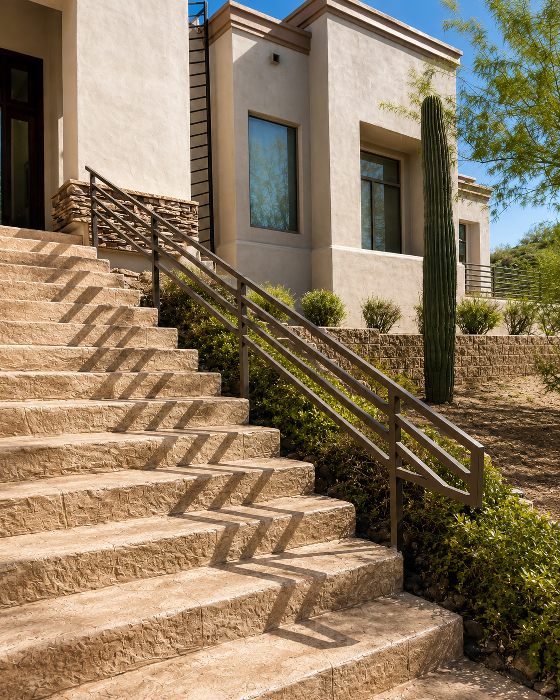 Steel chevron stair railing climbing to a desert-modern Scottsdale residence